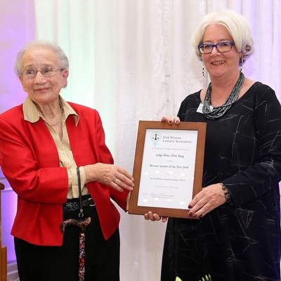 Justice Mary Ellen Ring receives her award from Justice Catherine McGuinness style=