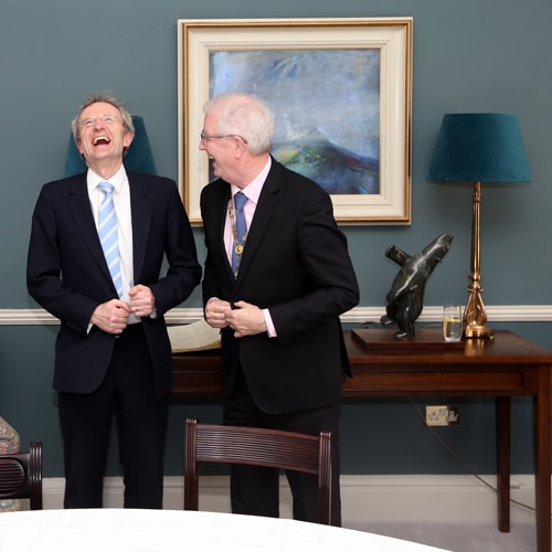 Mr Justice Michael Twomey shares a joke with Law Society President Michael Quinlan style=